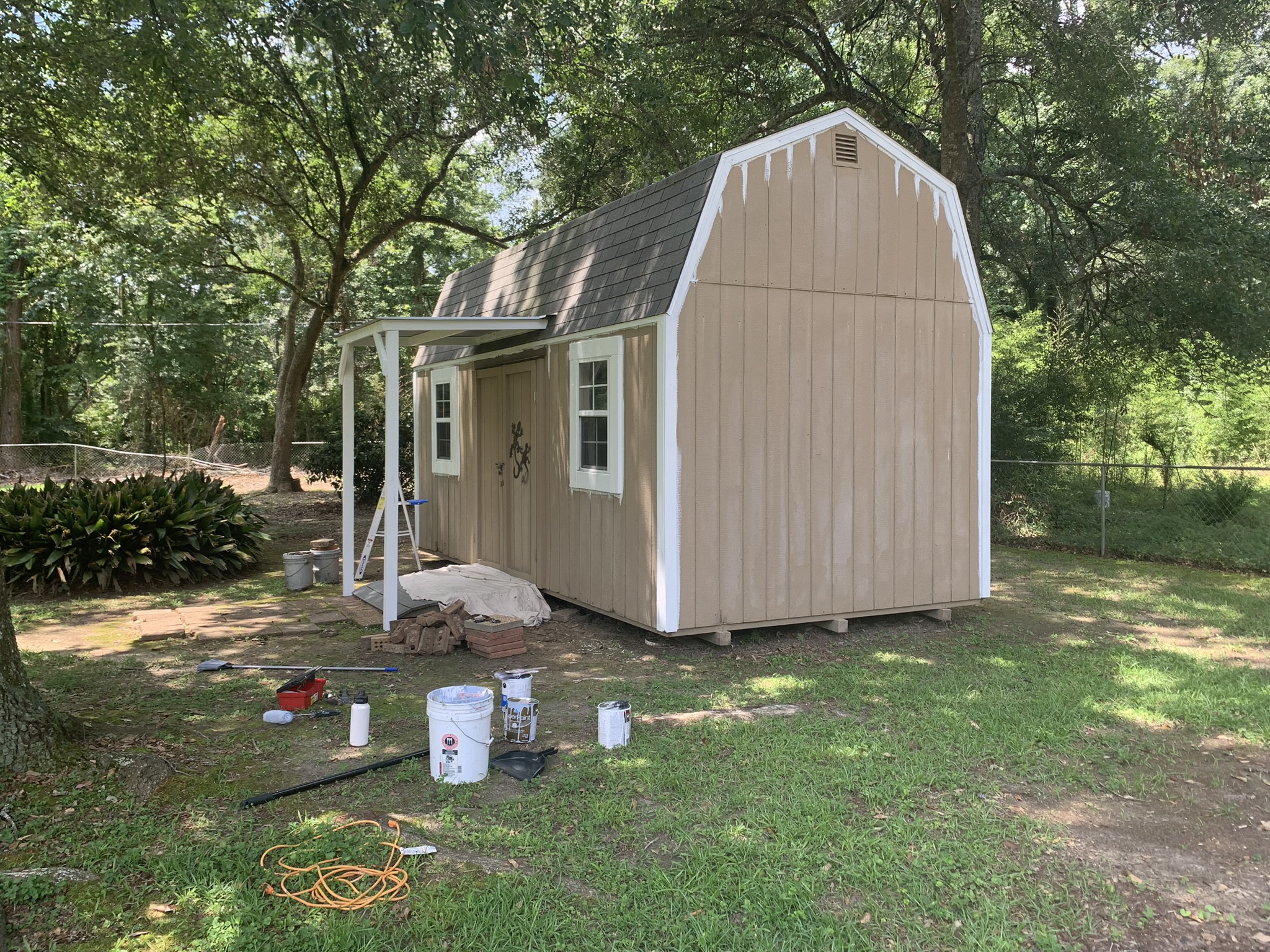 Shed Painted in Kiln MS by local painter Paint Star - brown wooden shed being painted trim