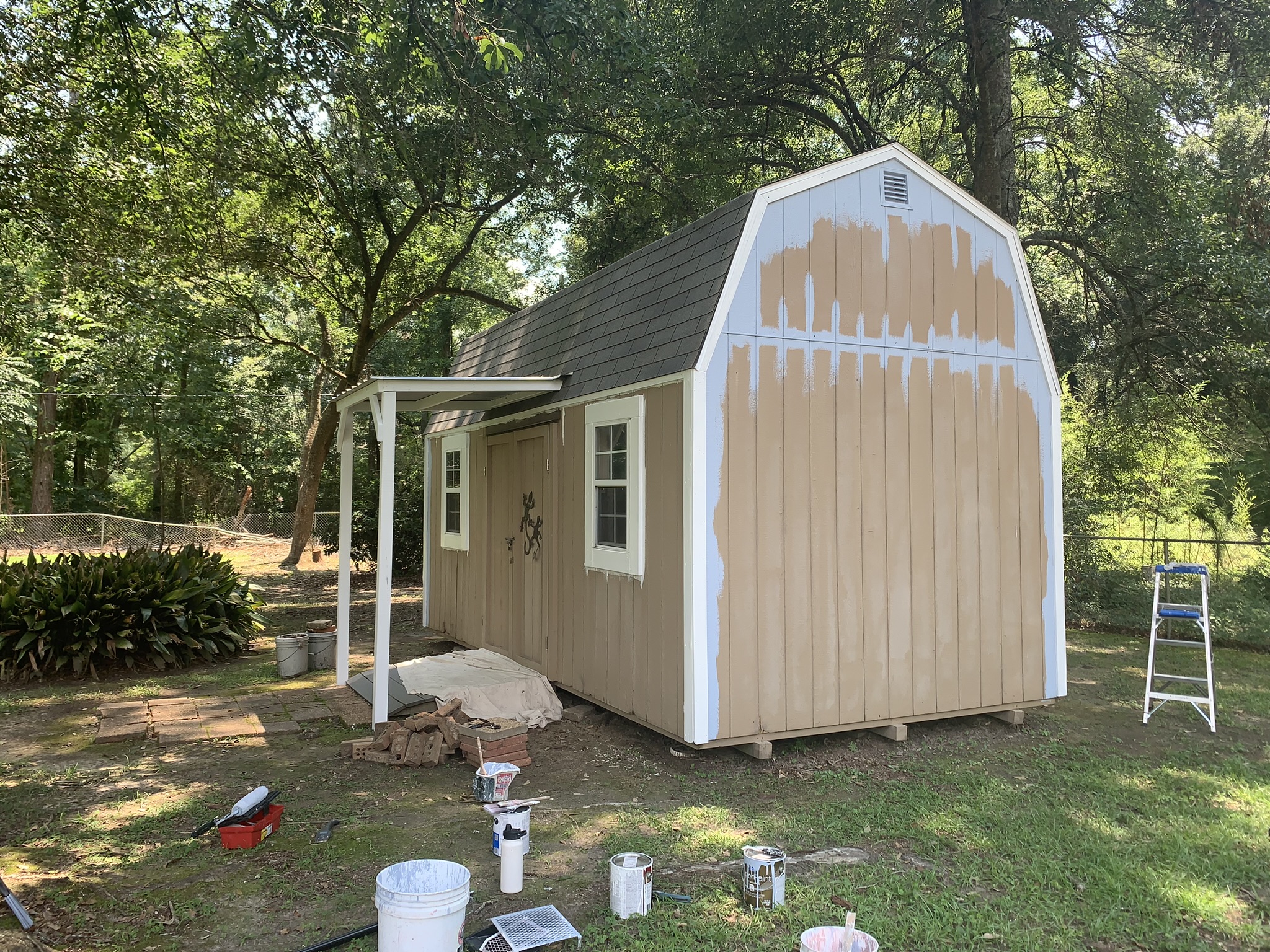 Shed Painted in Kiln MS by local painter Paint Star - brown wooden shed being painted Sherwin Williams Windy Blue